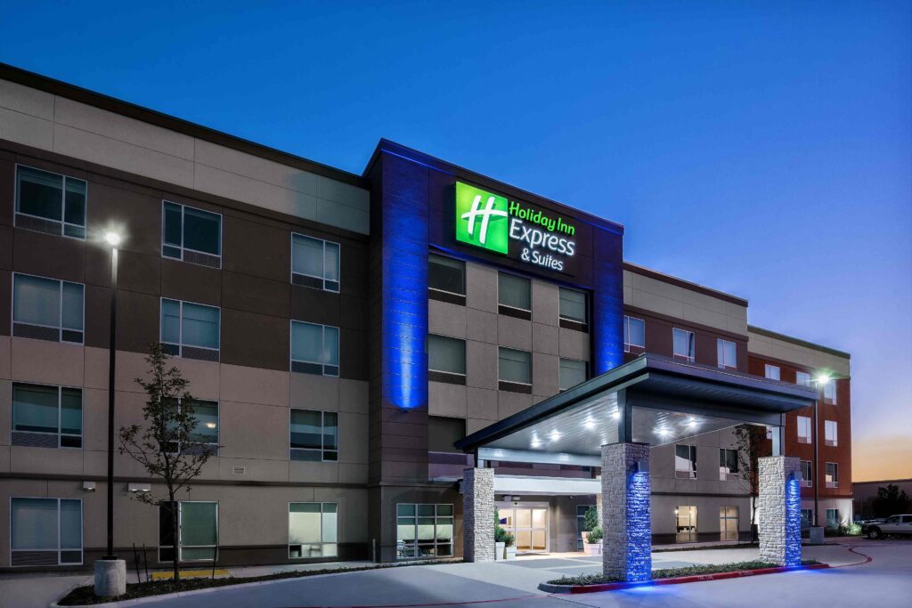 the front of a hotel with a lit up entrance
