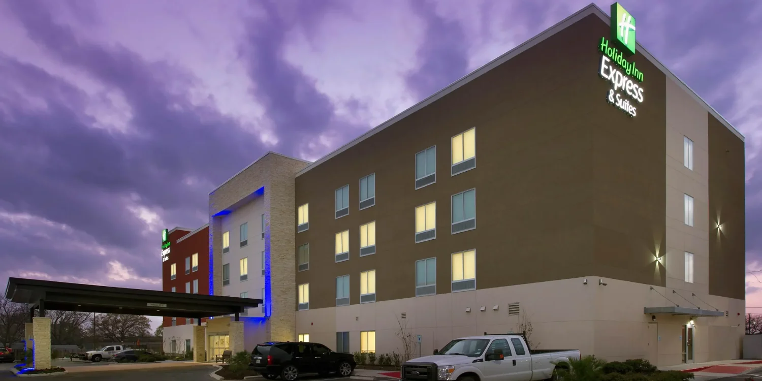 the front of a hotel with a truck parked in front of it