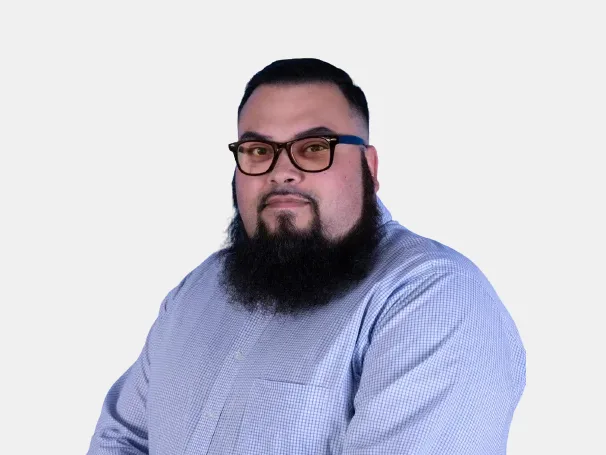 a man with a beard and glasses standing in front of a white background